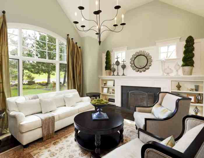 Living white room rooms couches space small couch chandelier fireplace large table lighted featuring along